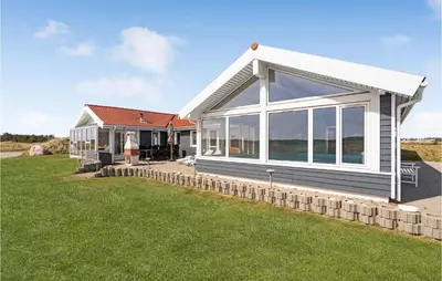a house with large windows and a lawn at Amazing Home In Thisted With Sauna in Thisted