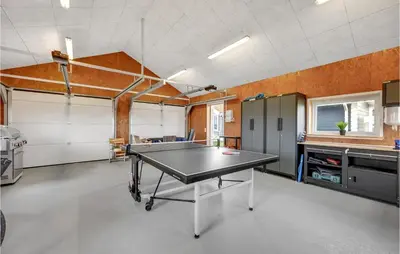 an empty garage with a ping pong table in it at Amazing Home In Thisted With Sauna in Thisted