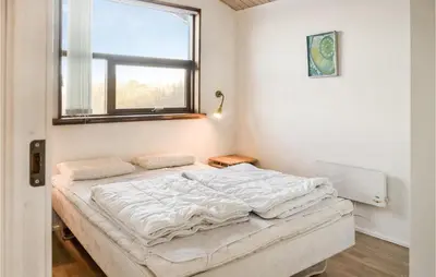 a bed in a room with a window at Holiday Home Hellesvej Vestervig Denm in Vestervig