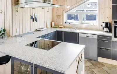 a kitchen with a sink and a counter top at Holiday Home Søtungevej in Thisted