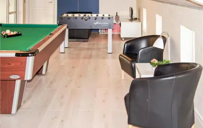 a billiard room with a pool table and chairs at Holiday Home Klitstien Ii in Thisted