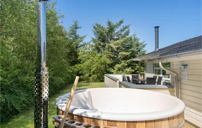 a jacuzzi tub on the patio of a house at Holiday Home Kristinesvej Thisted Vi in Thisted