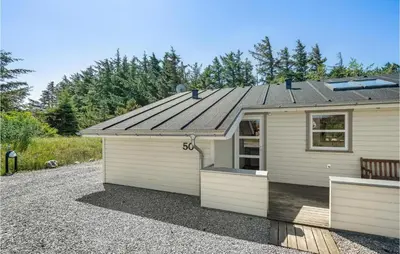 a small house with a tin roof on top at Holiday Home Kristinesvej Thisted Vi in Thisted