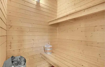 a wooden sauna with a bottle on a bench at Holiday Home Kristinesvej Thisted Vi in Thisted