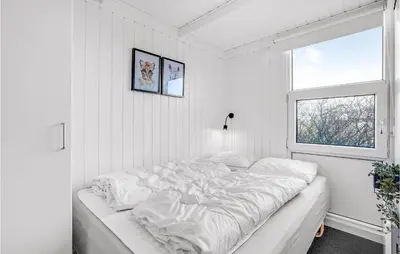 a white bedroom with a bed and a window at Stunning Home In Vestervig With Sauna in Vestervig
