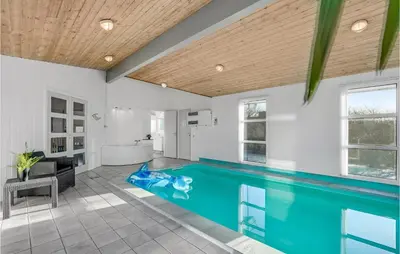 a large swimming pool in a bathroom with a tub at Stunning Home In Vestervig With Sauna in Vestervig