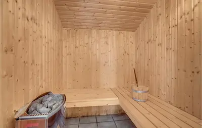 a wooden sauna with a bucket in the middle at Stunning Home In Vestervig With Sauna in Vestervig