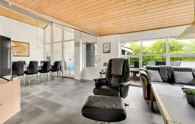 a living room with chairs and a table with a pool at 4 Bedroom Lovely Home In Vestervig in Vestervig