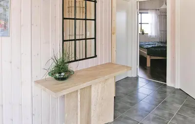 a room with a wooden bench with a plant on it at Casa Blanca in Thisted
