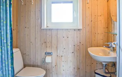 a bathroom with a toilet and a sink and a window at Stunning Home In Thisted With Sauna in Thisted