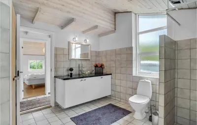 a bathroom with a toilet and a sink at Beautiful Home In Vestervig With Sauna in Vestervig