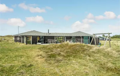a house on top of a grassy hill at Stunning Home In Thisted With Sauna in Thisted
