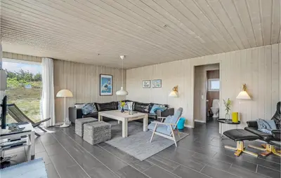 a living room with a couch and a table at Stunning Home In Thisted With Sauna in Thisted