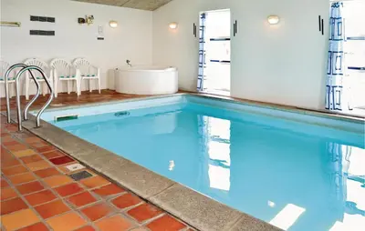 a large swimming pool with a tub in a house at Awesome Home In Thisted With Sauna in Thisted