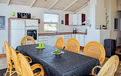a kitchen and dining room with a table and chairs at Three-Bedroom Holiday Home In Thisted in Thisted