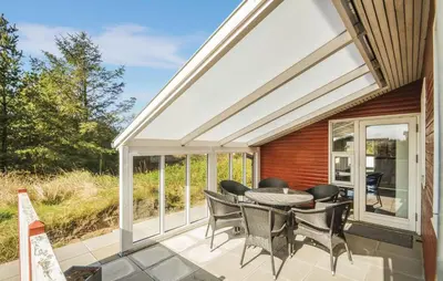a patio with a table and chairs on it at Three-Bedroom Holiday Home In Thisted in Thisted