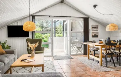 a living room with a table and a dining room at Three-Bedroom Holiday Home In Thisted in Thisted