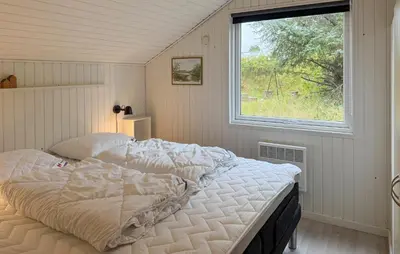 a bed in a room with a window at Three-Bedroom Holiday Home In Thisted in Thisted