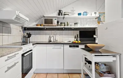 a white kitchen with white cabinets and a sink at Three-Bedroom Holiday Home In Thisted in Thisted