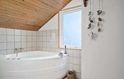 a white bath tub in a bathroom with a window at Three-Bedroom Holiday Home In Thisted in Thisted
