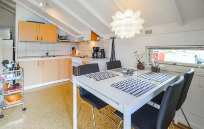 a kitchen with a table and chairs in a room at Two-Bedroom Holiday Home In Thisted in Thisted