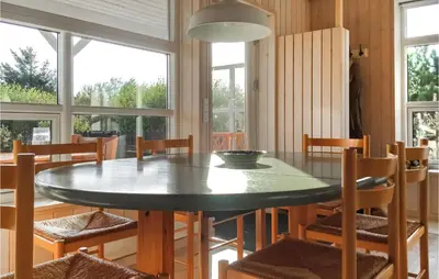 a dining room table with chairs and a bowl on it at Three-Bedroom Holiday Home In Thisted in Thisted