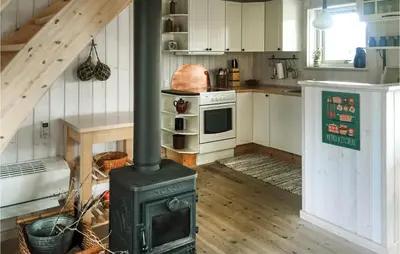 a kitchen with a stove in the middle of a room at Three-Bedroom Holiday Home In Thisted in Thisted