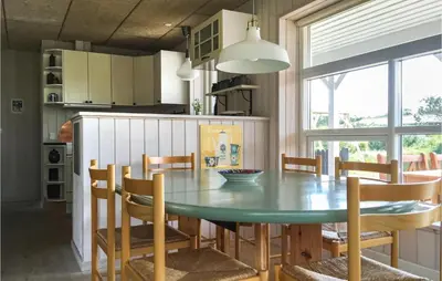 a kitchen with a dining room table and chairs at Three-Bedroom Holiday Home In Thisted in Thisted