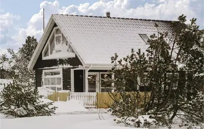 a house with snow on the ground in front of it at Three-Bedroom Holiday Home In Thisted in Thisted