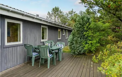 a patio with a table and chairs on a deck at Holiday Home Klemsvej in Thisted