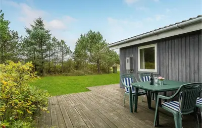 a patio with a table and chairs on a deck at Holiday Home Klemsvej in Thisted