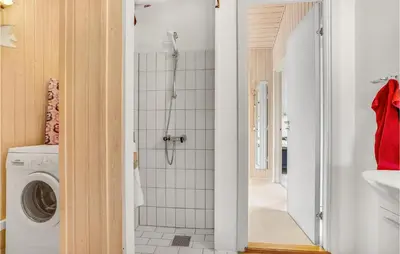a bathroom with a shower and a washing machine at Holiday Home Grårisvej Thisted V in Thisted