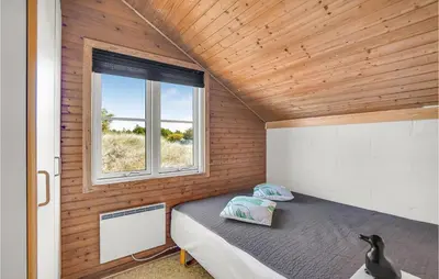 a bedroom in a tiny house with a window at Holiday Home Grårisvej Thisted Vi in Thisted