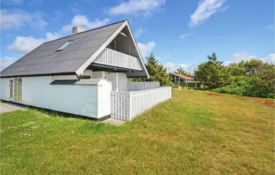 a small white building with a black roof on a field at Holiday Home Fiskervej Thisted Iii in Thisted