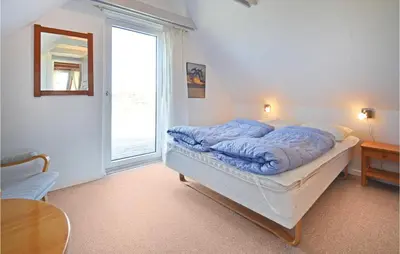 a bed in a room with a large window at Holiday Home Fiskervej Thisted Iii in Thisted