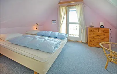 a bedroom with a bed and a dresser and a window at Holiday Home Fiskervej Thisted Iii in Thisted