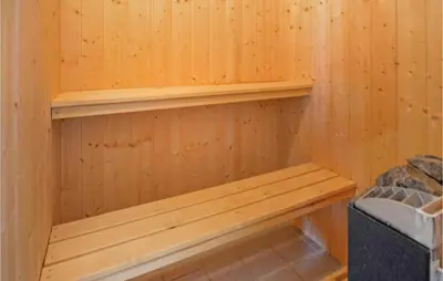 a wooden sauna with a wooden bench in it at Holiday Home Fiskervej Thisted Iii in Thisted