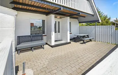 a patio with a bench and a picnic table at Holiday Home Fiskervej Thisted Iii in Thisted