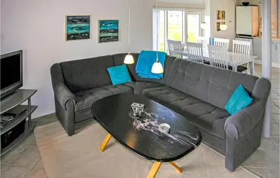 a living room with a couch and a table at Holiday Home Fiskervej Thisted Iii in Thisted