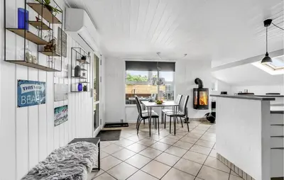 a kitchen and dining room with a table and chairs at Holiday Home Fiskervej Thisted Iv in Thisted