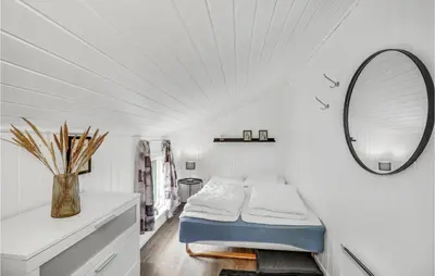 a white room with a bed and a mirror at Holiday Home Fiskervej Thisted Iv in Thisted
