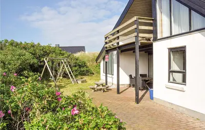 a house with a patio and a swing at Holiday Home Ørredvej Thisted Ii in Thisted