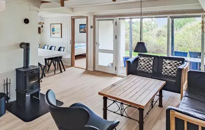 a living room with a couch and a wood stove at Holiday Home Ørredvej Thisted Ii in Thisted