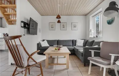 a living room with a couch and a table at Holiday Home Stenbjerg Kirkevej in Snedsted