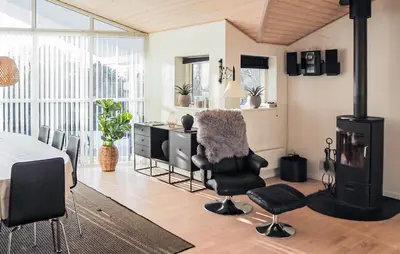 a living room with a table and a desk with chairs at Holiday Home Gunhildsvej Vestervig Xi in Vestervig