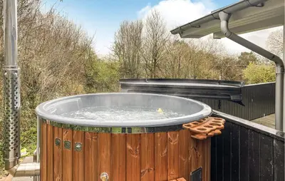 a hot tub sitting on a deck with water at Holiday Home Gunhildsvej Vestervig Xi in Vestervig