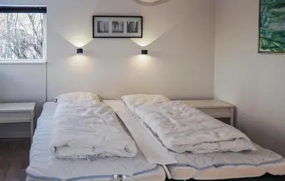 a bed with white sheets in a room with a window at Holiday Home Gunhildsvej Vestervig Xi in Vestervig