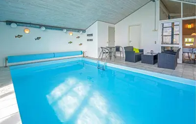 a large swimming pool with a table and chairs at Awesome Home In Vestervig With Kitchen in Vestervig