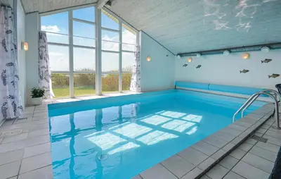 a swimming pool in a room with a large window at Awesome Home In Vestervig With Kitchen in Vestervig