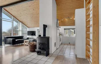 a living room with a wood stove in it at Holiday Home Gunhildsvej Vestervig Vi in Vestervig